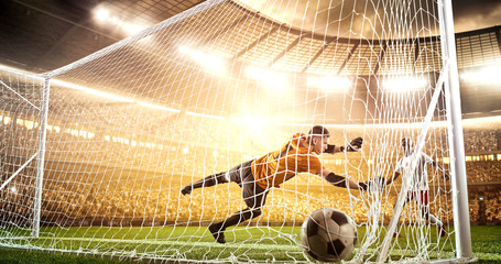 Intense soccer moment in front of the goal on the professional soccer stadium.