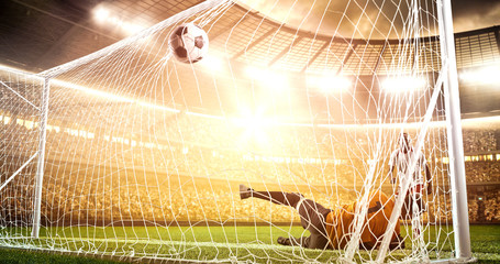 Intense soccer moment in front of the goal on the professional soccer stadium.