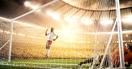 Intense soccer moment in front of the goal on the professional soccer stadium.