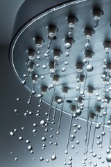 Shower Head with Water Stream on Grey Background