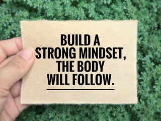 Obraz premium Motivational and inspirational quote - Build a strong mindset, the body will follow. Blurred styled background.