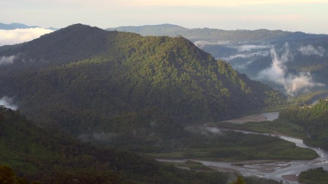 The Rio Abanico Valley with misty cloudforest covered hillsides. Forested slopes illuminated by the evening sun.  On the Amazonian slopes of the Andes in Morona Santiago province