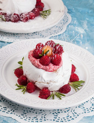 Meringue pavlova cake with whipped cream and fresh raspberries