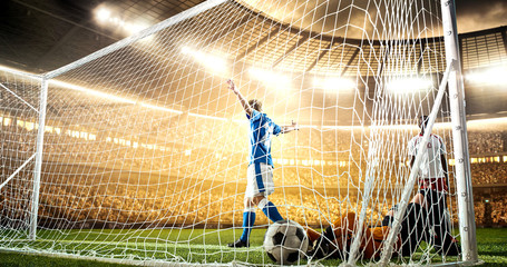 Intense soccer moment in front of the goal on the professional soccer stadium.