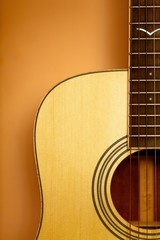 Obraz premium Guitar Standing on Orange Background - Close Up