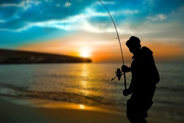 Silhouette of fishing man on coast - obrazy, fototapety, plakaty