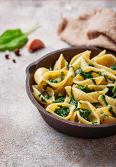 Conchiglioni pasta with spinach in creamy sauce 
