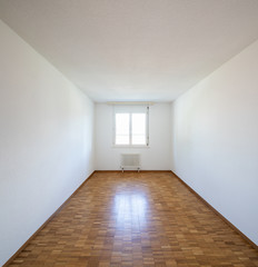 Empty room with window and parquet