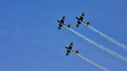 at the air show three aircraft in the blue sky at demonstrations
