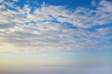 An island emerging from the early morning freezing fog.