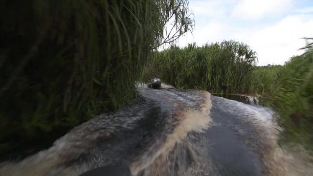 fast boats on river driving through the Jungle of Borneo, indonesia