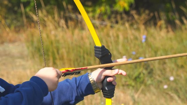 Training in archery. Boy learn archery