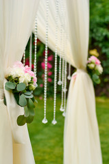 bouquets of flowers at the wedding arch