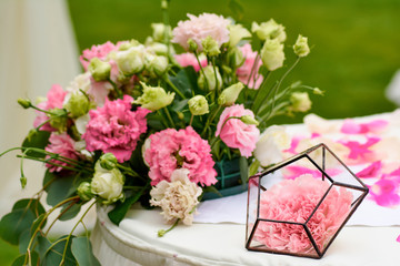 wedding bouquet and rose petals on the white table