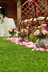 Fototapeta na wymiar wedding bouquet and rose petals outdoors