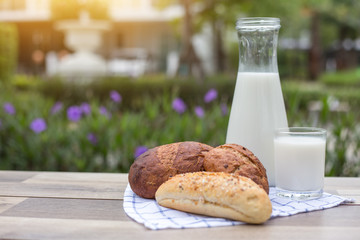 Bread,fresh bread and milk on the table.