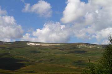 Natural landscape photo of fantastic mountain landscape with bright blue overcast sky on background