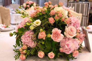 a bouquet of flowers on a table in the restaurant