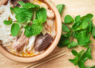 Thai vermicelli eaten with curry and vegetable on wood cup