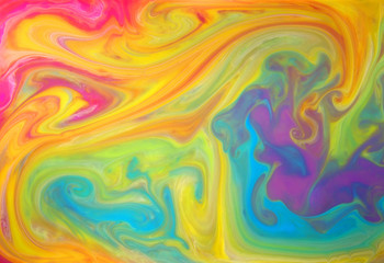 Obraz premium Colored liquids mixed together in fluid creating colorful abstract background