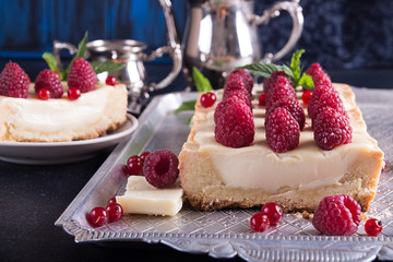 Tarte shortcake with mascarpone, white chocolate and cream served with fresh raspberries and red currant.
