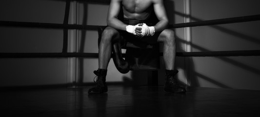  young boxer sitting on the boxing ring