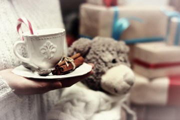 cup in hand and stack gifts