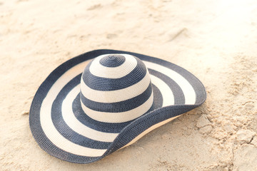 Fototapeta na wymiar Straw hat on the beach in summer vacation.