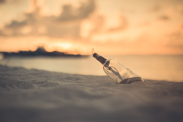 Bottle with a message. Abstract cast away concept, tropical beach and message in the bottle