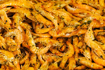 Shrimps fried on pan and fresh herbs