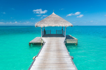 Wooden jetty in tropical sea, in Maldives. Inspirational seascape, and tropical nature view