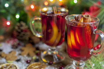  mulled wine on table with Christmas decorations in blur background.