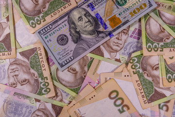 American one hundred dollars banknote on the many ukrainian hryvnas