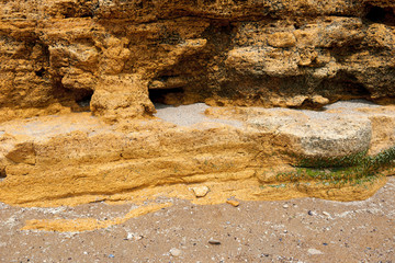 closeup of stone on the beach, sea coast with high hills, beautiful wild landscape
