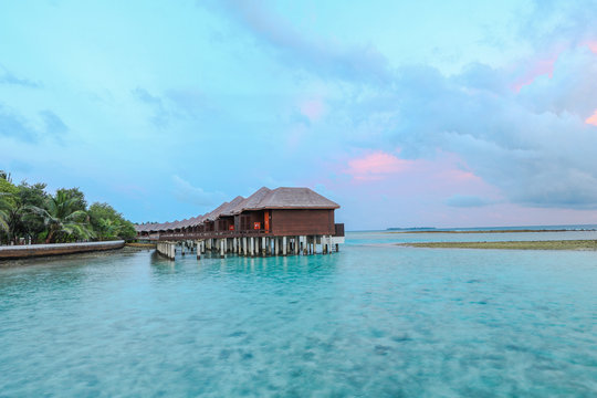 Amazing island in the Maldives ,water villa ,wooden bridge and  beautiful  turquoise waters with  blue sky  background for holiday vacation .