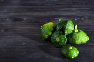 small size patty pan patisson squash on dark wooden background with copy space