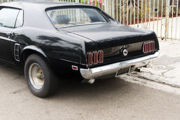 A view of a classic vintage American muscle car in the street