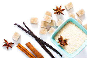 Food background brown sugar, vanilla pods, cinnamon stick and star anise on white background