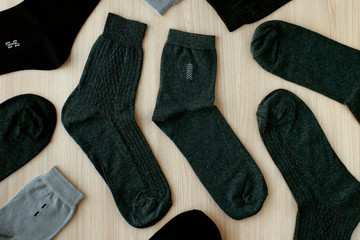 Classic men's socks. View from above. Many socks for men are gray and black. Clothing for men in the form of socks.