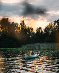 Fototapeta na wymiar Golden sky with rowing boat