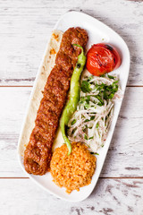 Adana Kebab Served with Green Vegetables in  White Plate