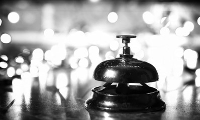 reception bell on the table and shining garland background