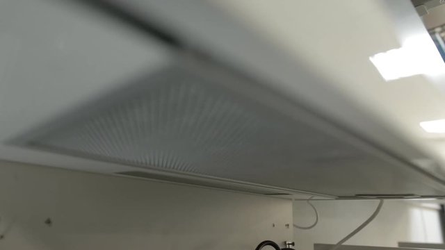 Fat filter in the new modern kitchen hood, close-up, electric