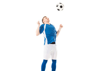 athletic young soccer player hitting ball with chest isolated on white