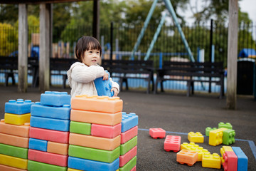 Fototapeta na wymiar Baby girl play at outdoor playground