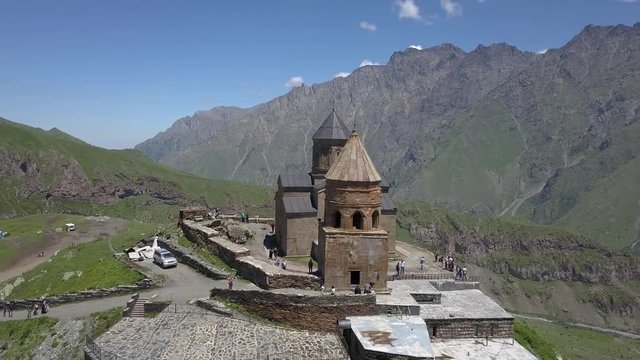 Aerial view to Gergeti Trinity Church or Tsminda Sameba, Holy Trinity Church near the village of Gergeti in Georgia, under Mount Kazbegi, Georgia