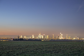 skyline of Frankfurt  in early morning with illuminated skyscraper