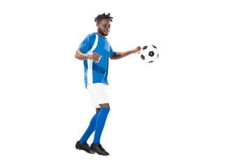 Fototapeta na wymiar full length view of athletic african american sportsman playing with soccer ball isolated on white