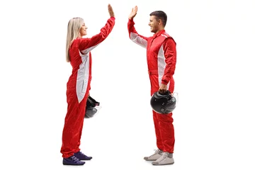Vlies Fototapete Motorsport Female and a male racer high-fiving each other