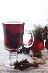 Hot mulled wine with Christmas cookies and New Year decor, vertical